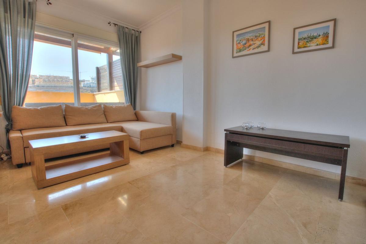 Penthouse with easy walk to La Cala de Mijas, featuring communal pool, paddle court, large terrace with sun all day, enclosed extra room, bright lounge, separate kitchen, en-suite bathroom, underground parking.