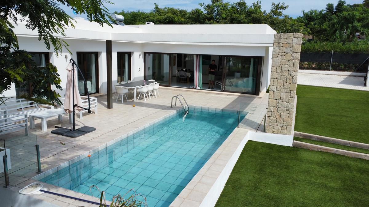 Spacious 5-bedroom Ibiza villa with high-end finishes, fully furnished, featuring a beautiful swimming pool and outdoor area, full heating system, air conditioning, electric gates, and parking.