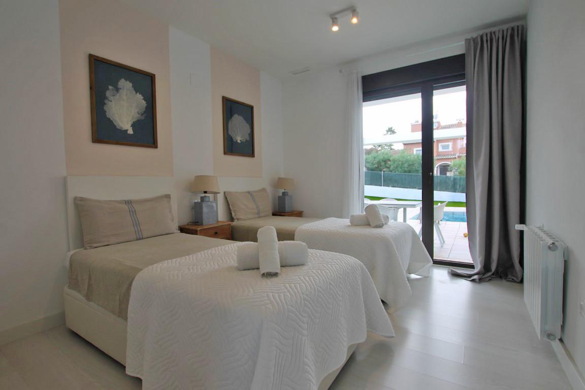 Spacious 5-bedroom Ibiza villa with high-end finishes, fully furnished, featuring a beautiful swimming pool and outdoor area, full heating system, air conditioning, electric gates, and parking.